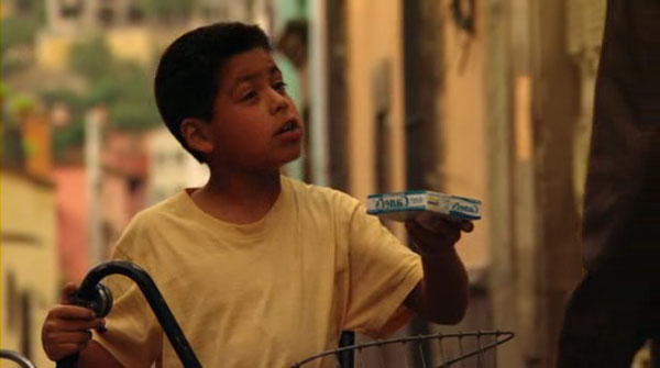 A boy in the street selling bubblegum